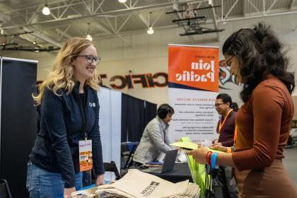 A student gets information at a booth during University of the Pacific's Career Expo.